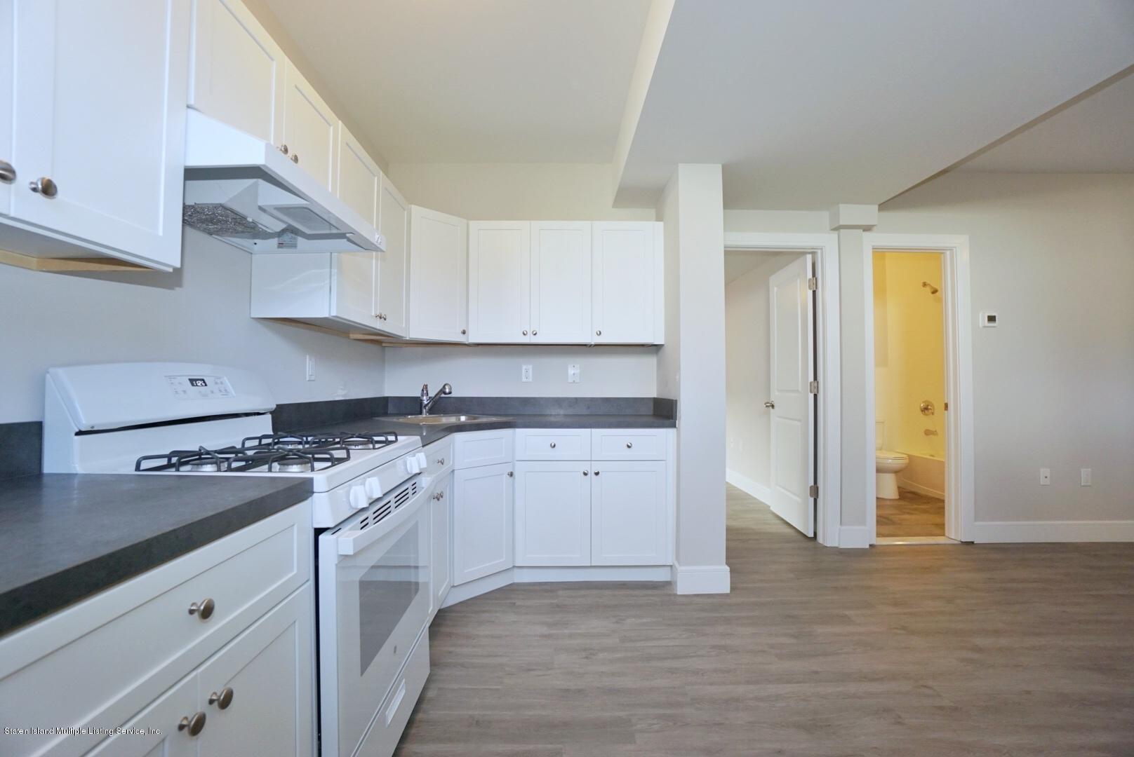 31 Torrice Loop Staten Island, NY 10309 - Photo 57 of 69 a kitchen with granite countertop a sink stove and cabinets