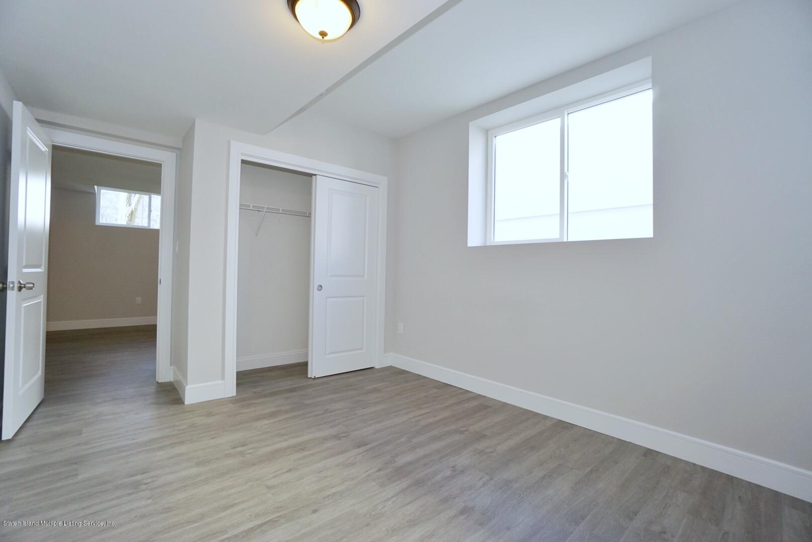 31 Torrice Loop Staten Island, NY 10309 - Photo 60 of 69 an empty room with wooden floor and windows