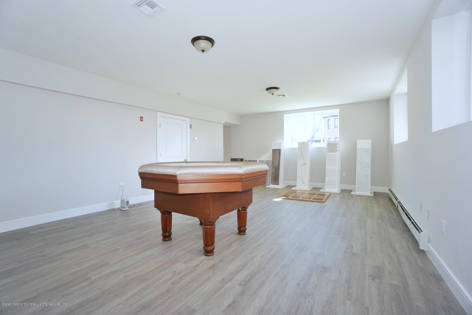 31 Torrice Loop Staten Island, NY 10309 - Photo 62 of 69 a room with a table and chairs