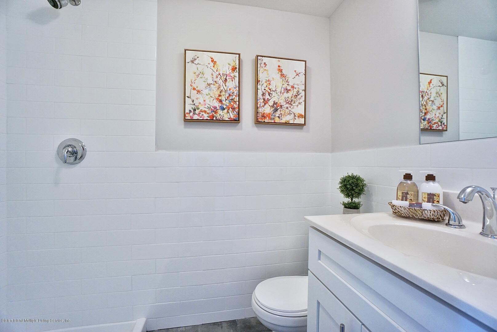 31 Torrice Loop Staten Island, NY 10309 - Photo 66 of 69 a bathroom with a granite countertop sink mirror vanity and toilet
