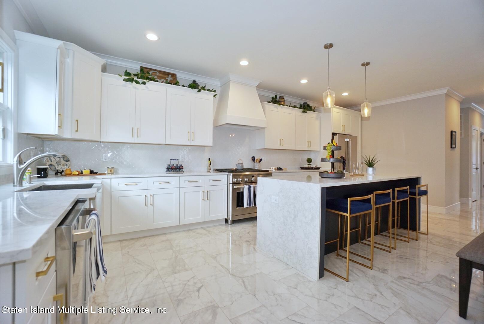 31 Torrice Loop Staten Island, NY 10309 - Photo 8 of 69 a kitchen with kitchen island granite countertop a sink a counter top space stainless steel appliances and cabinets