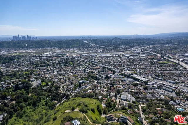 an aerial view of residential houses with outdoor space and mountain view