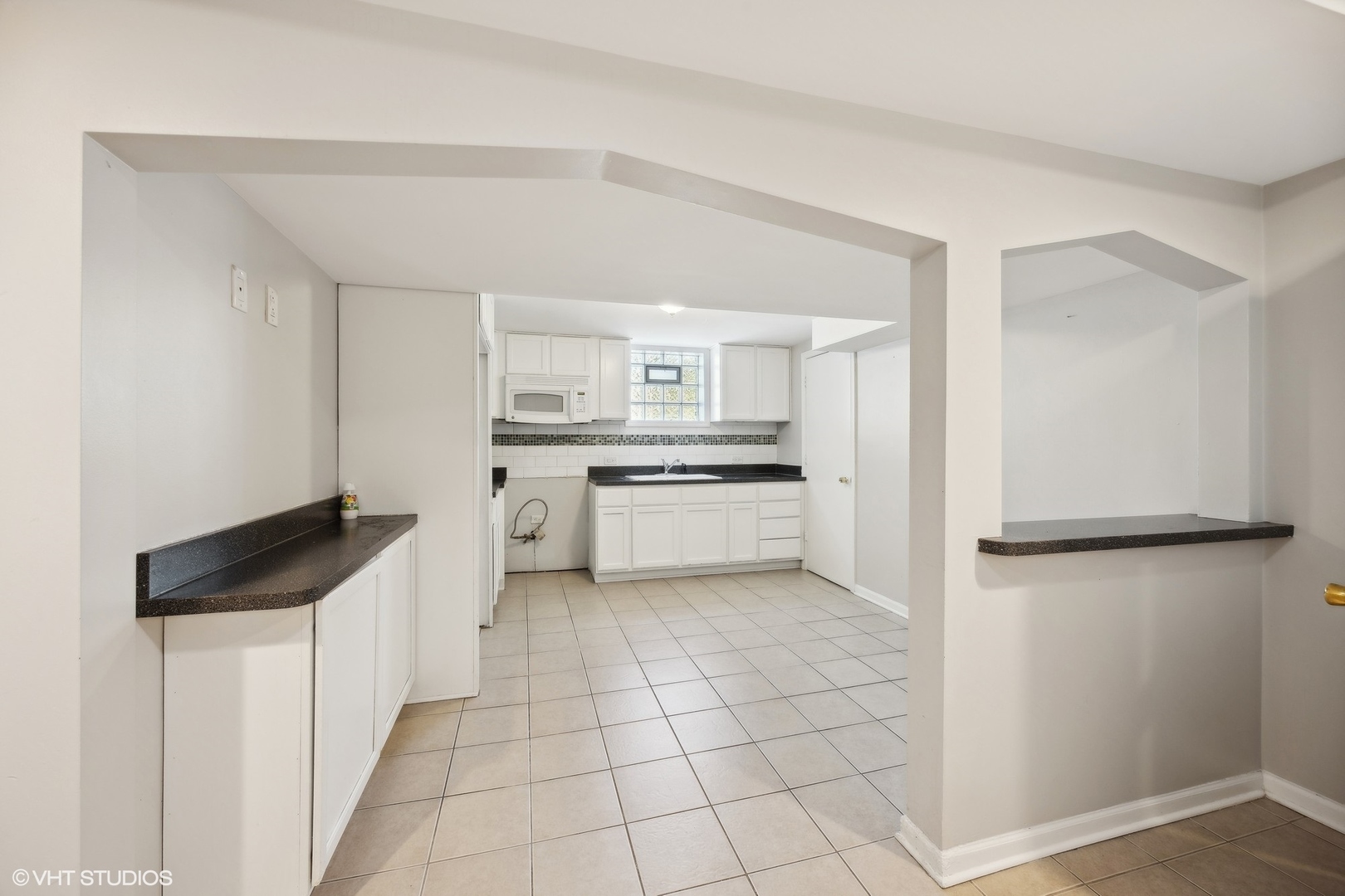 8152 Mayfield Avenue Burbank, IL 60459 - Photo 18 of 27 a kitchen with white cabinets and white appliances