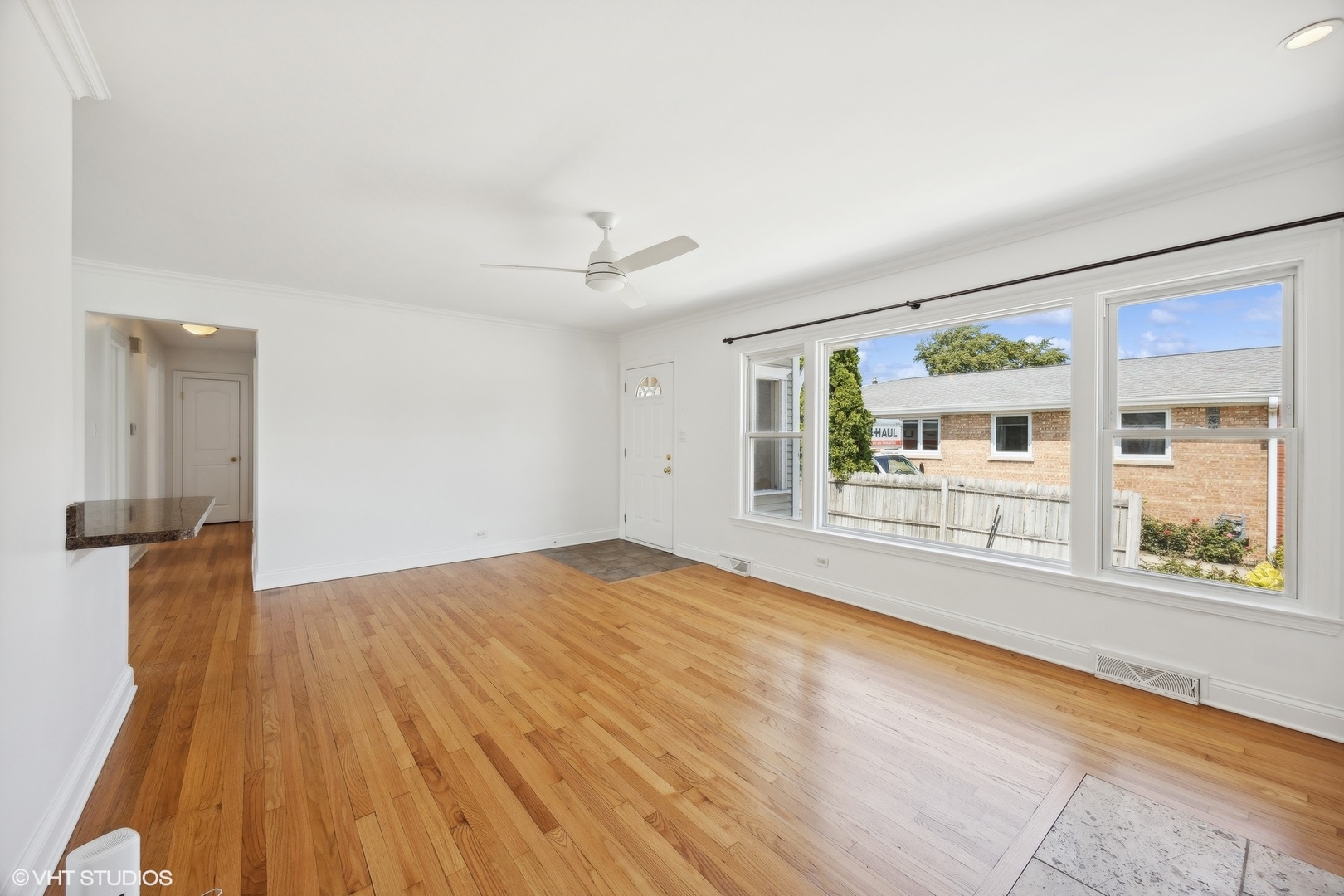 8152 Mayfield Avenue Burbank, IL 60459 - Photo 5 of 27 a view of an empty room with a window and wooden floor