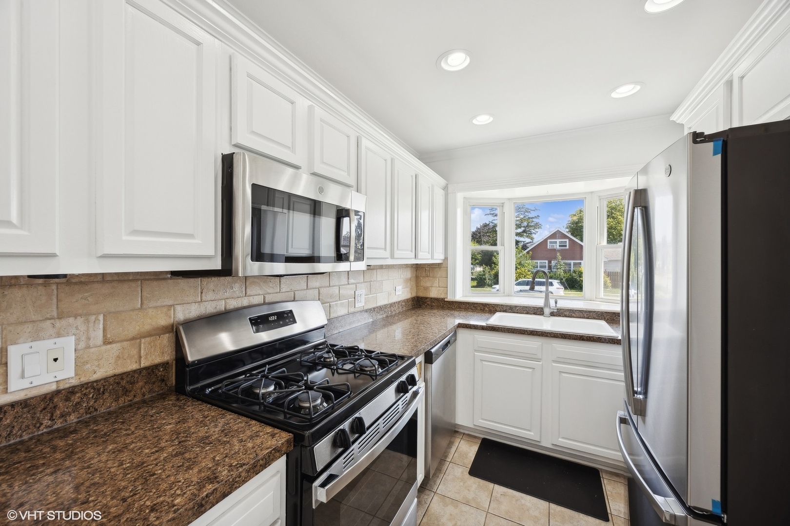 8152 Mayfield Avenue Burbank, IL 60459 - Photo 9 of 27 a kitchen with stainless steel appliances granite countertop a stove a sink and a microwave