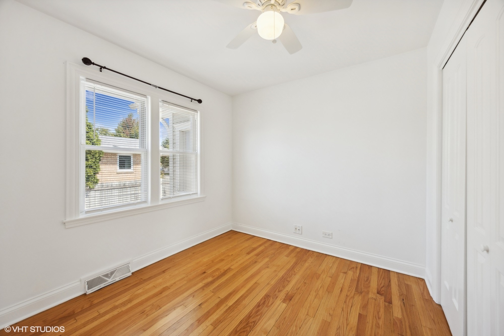 8152 Mayfield Avenue Burbank, IL 60459 - Photo 10 of 27 a view of an empty room with wooden floor and a window