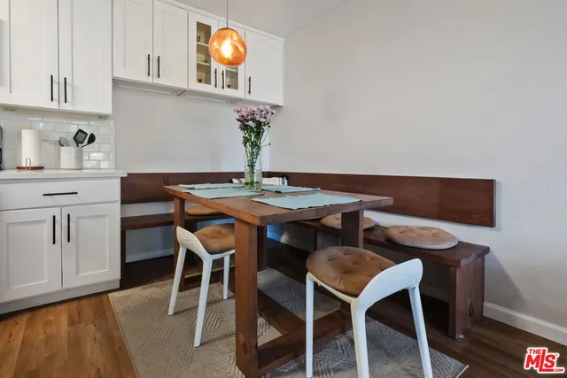 a kitchen with granite countertop a sink stove and refrigerator