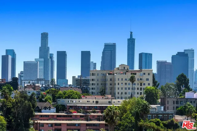 a bedroom with a bed a mirror and dresser