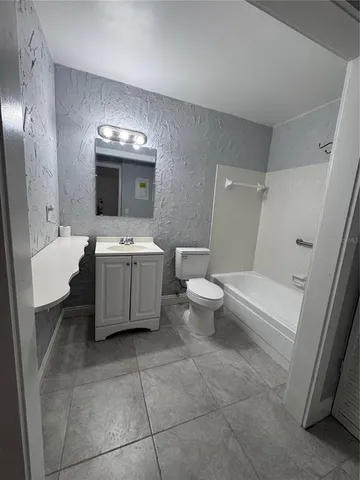 a view of building with swimming pool and tall trees