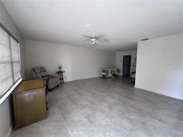 a view of a livingroom with furniture and a window