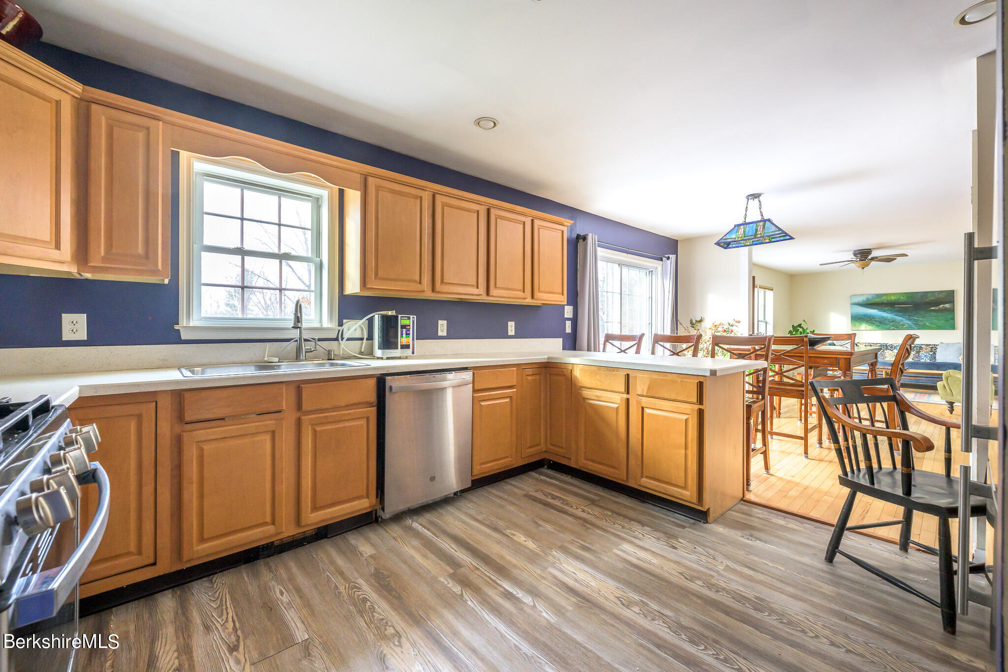 15 Alma Street Pittsfield, MA 01201 - Photo 15 of 35 a kitchen with wooden floors and white cabinets