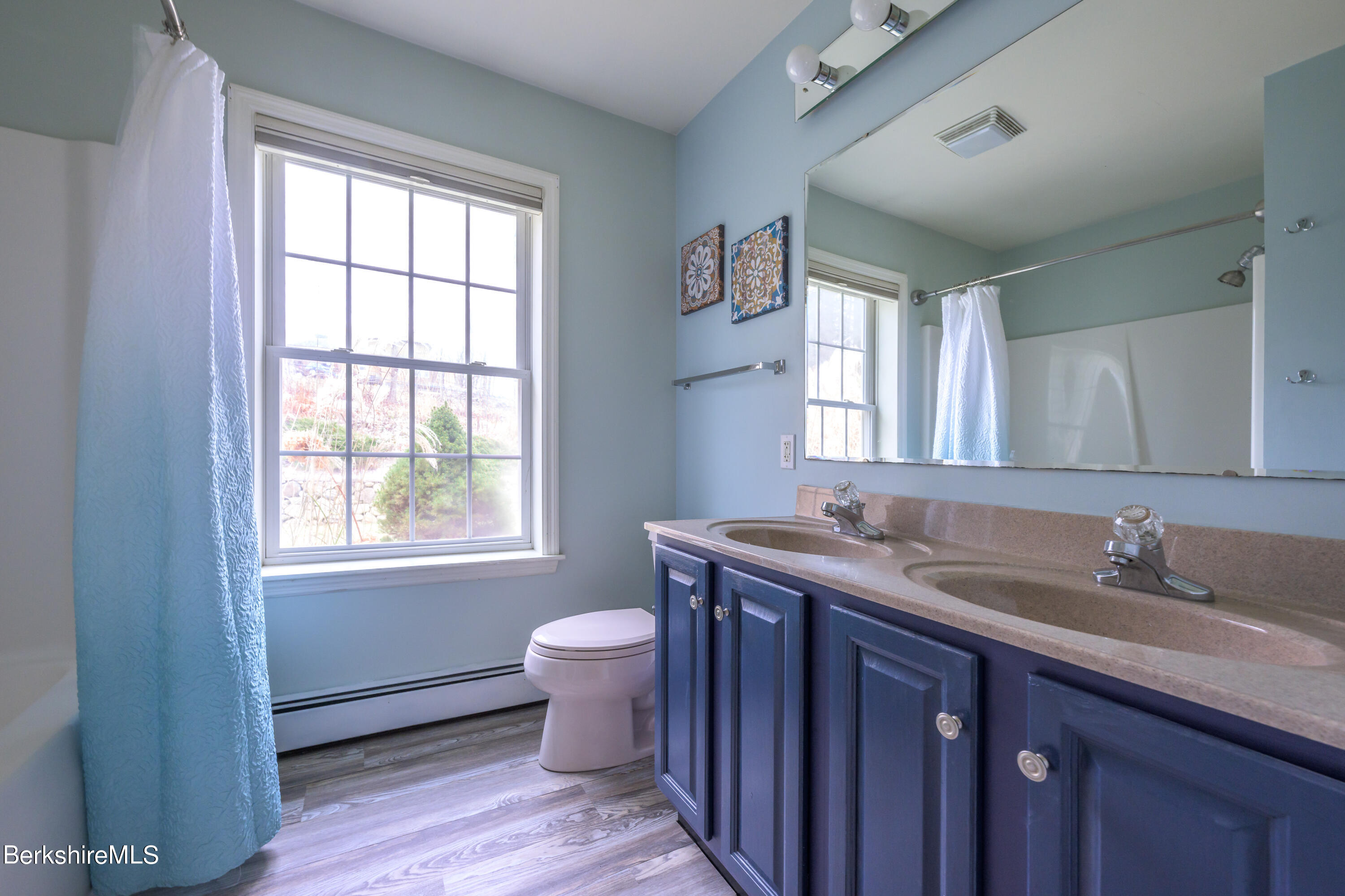 15 Alma Street Pittsfield, MA 01201 - Photo 23 of 35 a bathroom with a granite countertop toilet a sink and a window