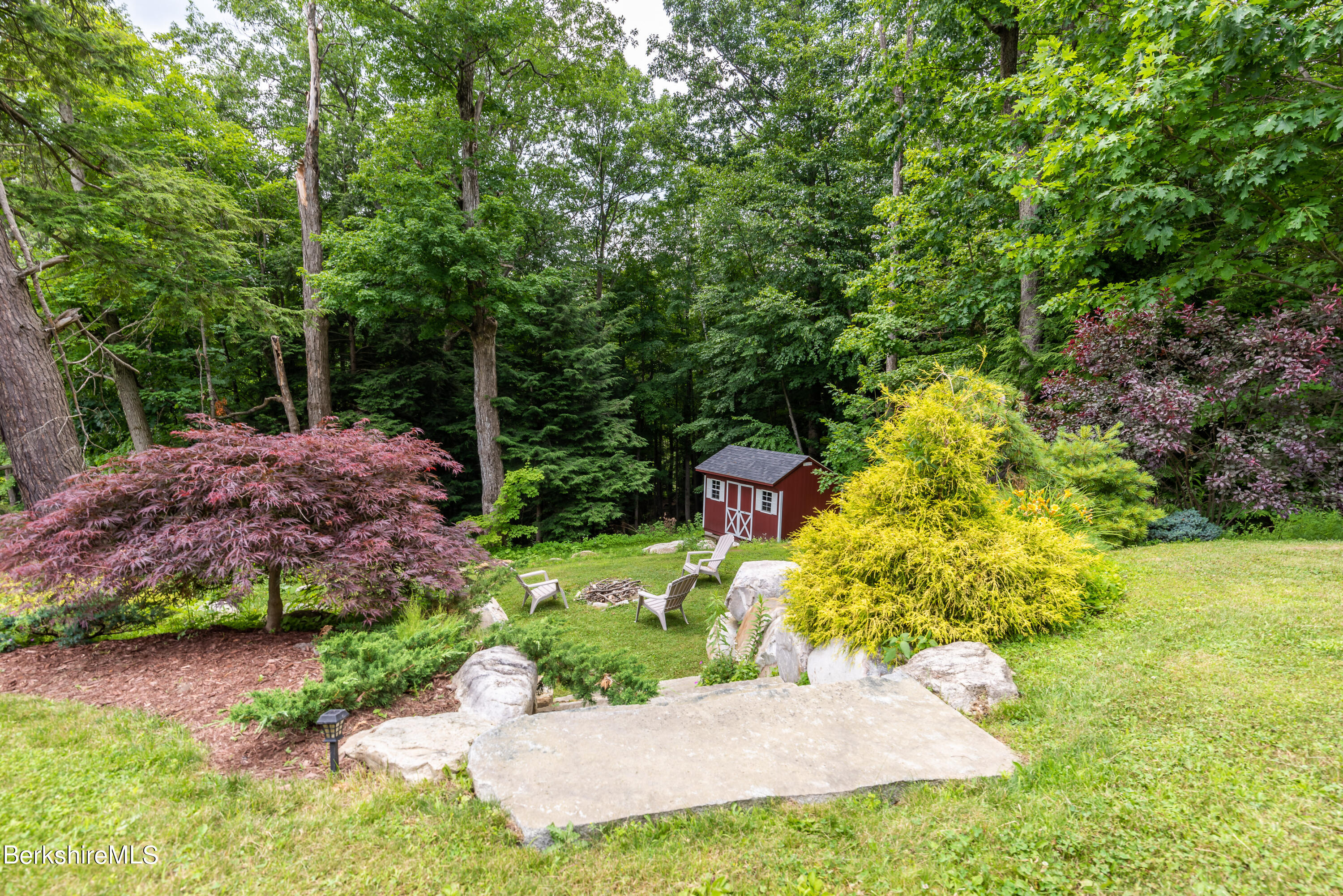 15 Alma Street Pittsfield, MA 01201 - Photo 31 of 35 a view of a garden with plants and large trees