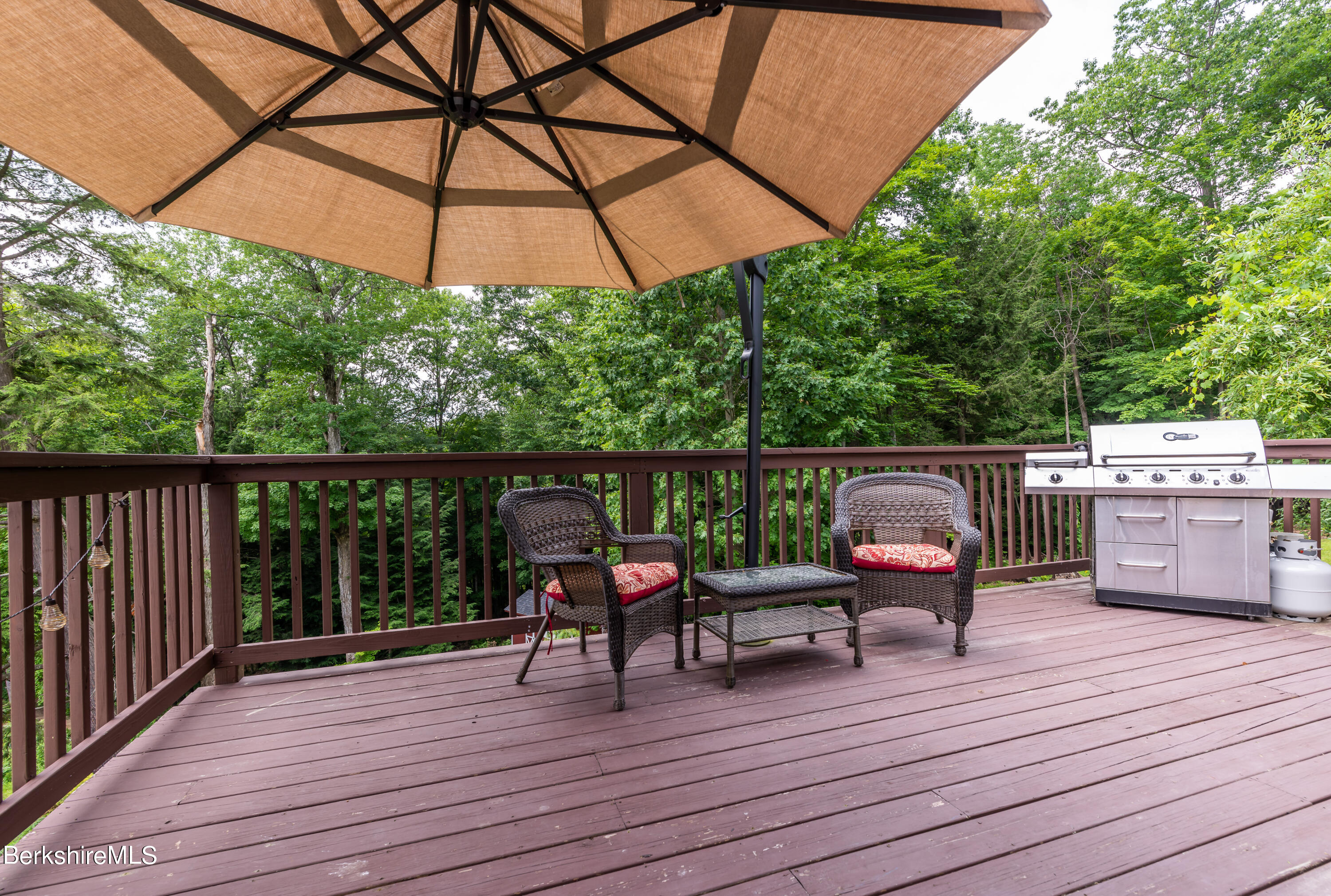 15 Alma Street Pittsfield, MA 01201 - Photo 7 of 35 a view of deck with table and chairs under an umbrella with wooden floor