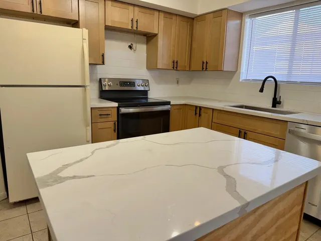 a kitchen with a refrigerator and a sink