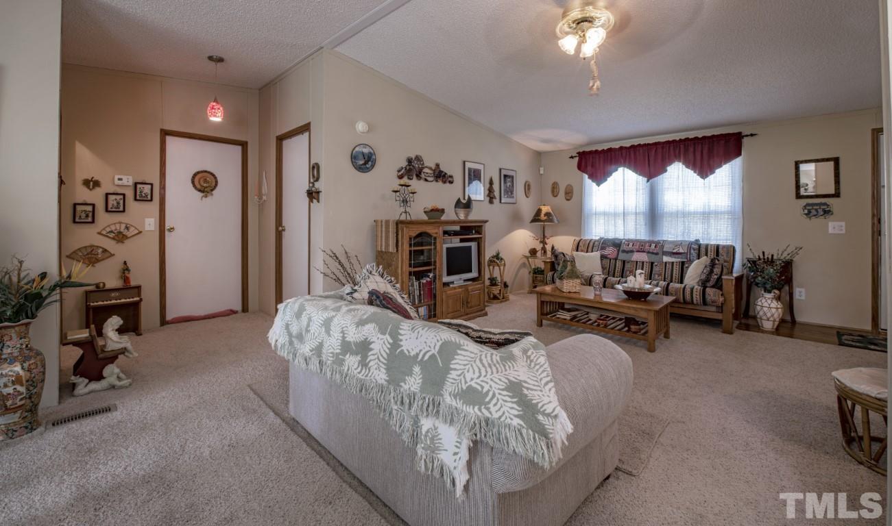 12411 West Old Spring Hope Road Middlesex, NC 27557 - Photo 11 of 28 a living room with furniture and a flat screen tv