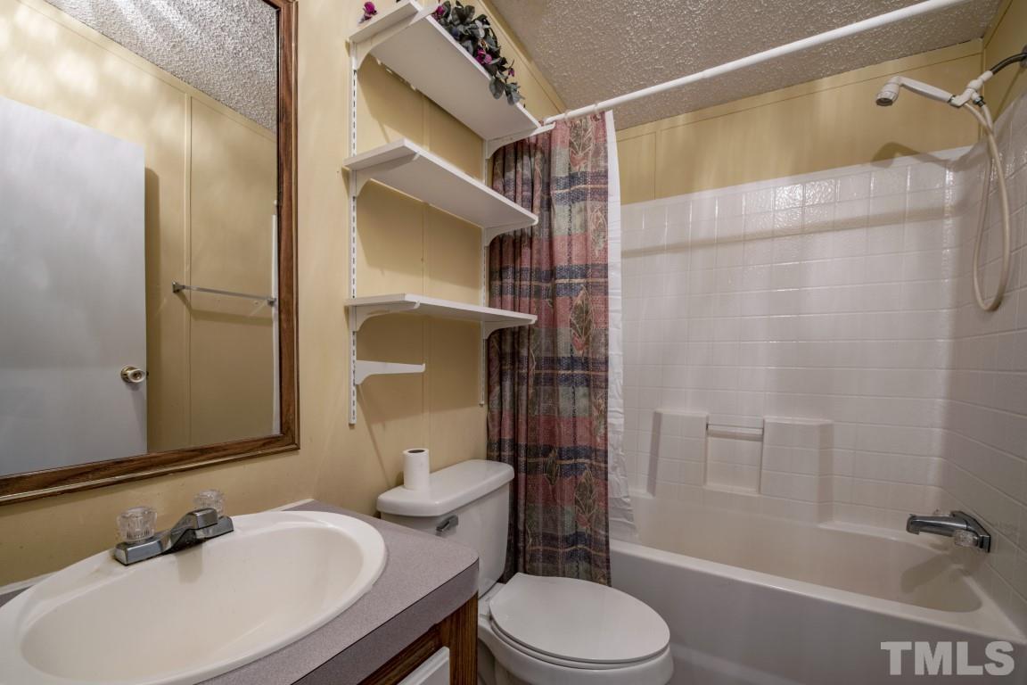12411 West Old Spring Hope Road Middlesex, NC 27557 - Photo 13 of 28 a bathroom with a sink toilet and shower