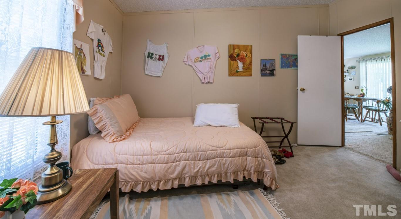 12411 West Old Spring Hope Road Middlesex, NC 27557 - Photo 19 of 28 a bedroom with a bed and a lamp