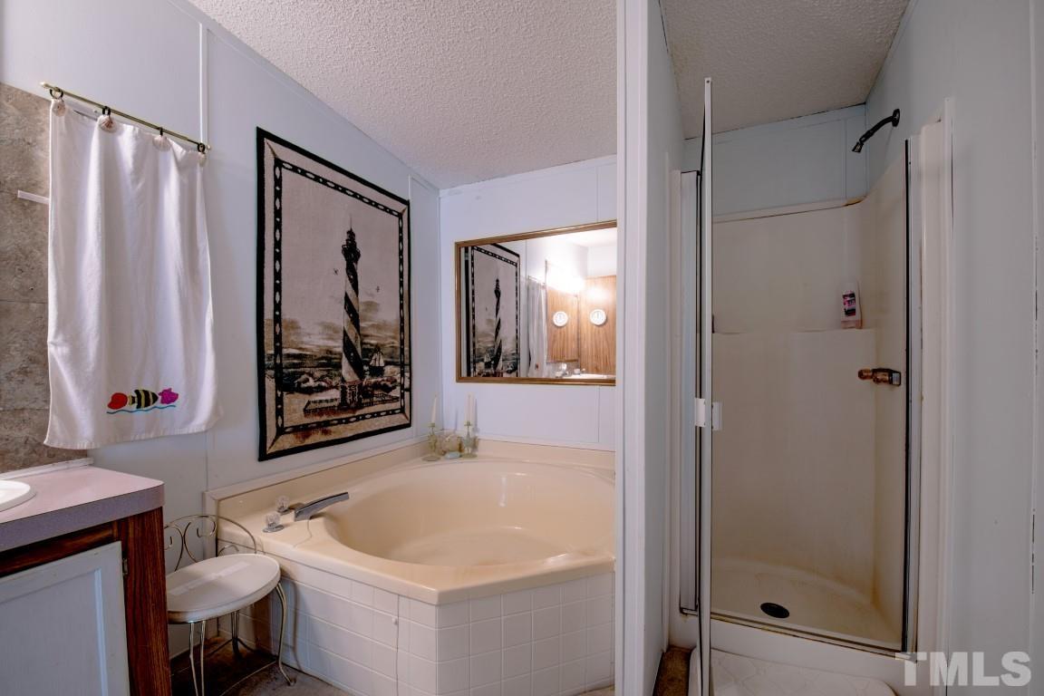 12411 West Old Spring Hope Road Middlesex, NC 27557 - Photo 23 of 28 a bathroom with a sink toilet and shower