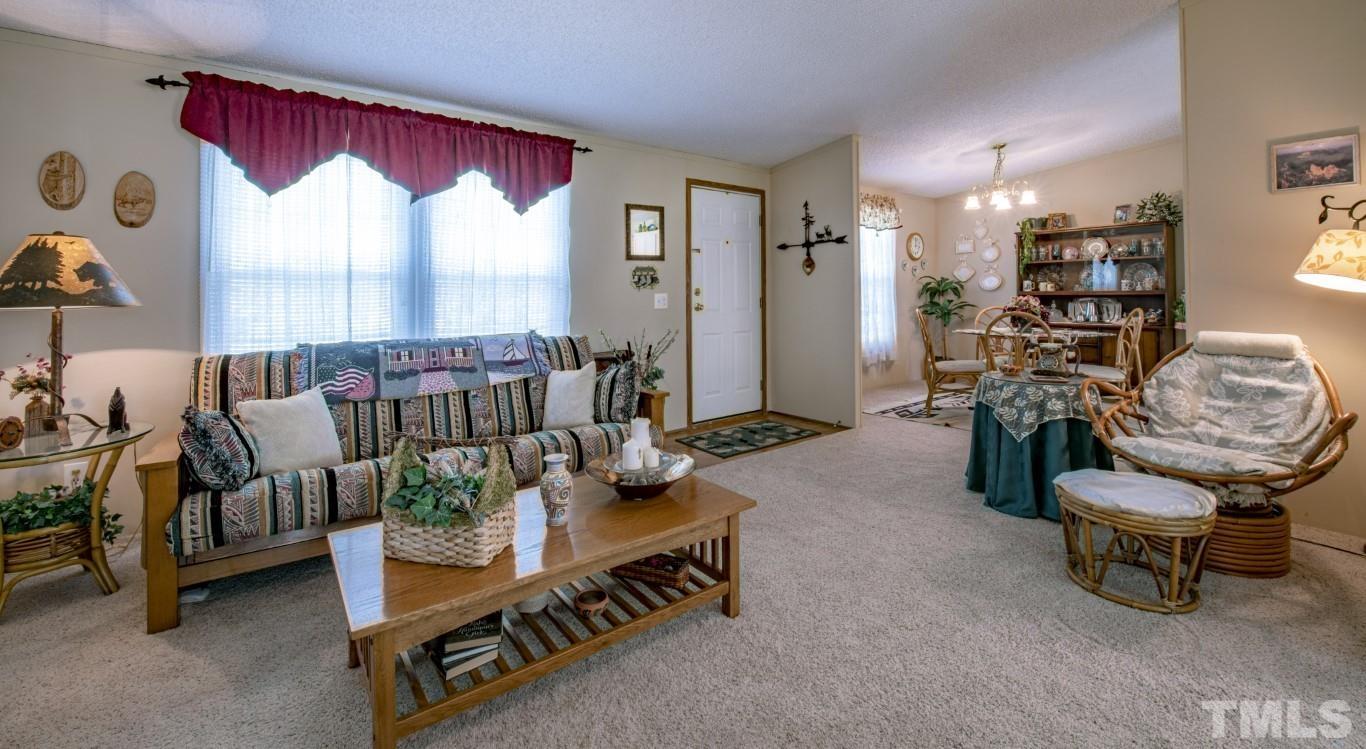 12411 West Old Spring Hope Road Middlesex, NC 27557 - Photo 7 of 28 a living room filled with furniture and a large window