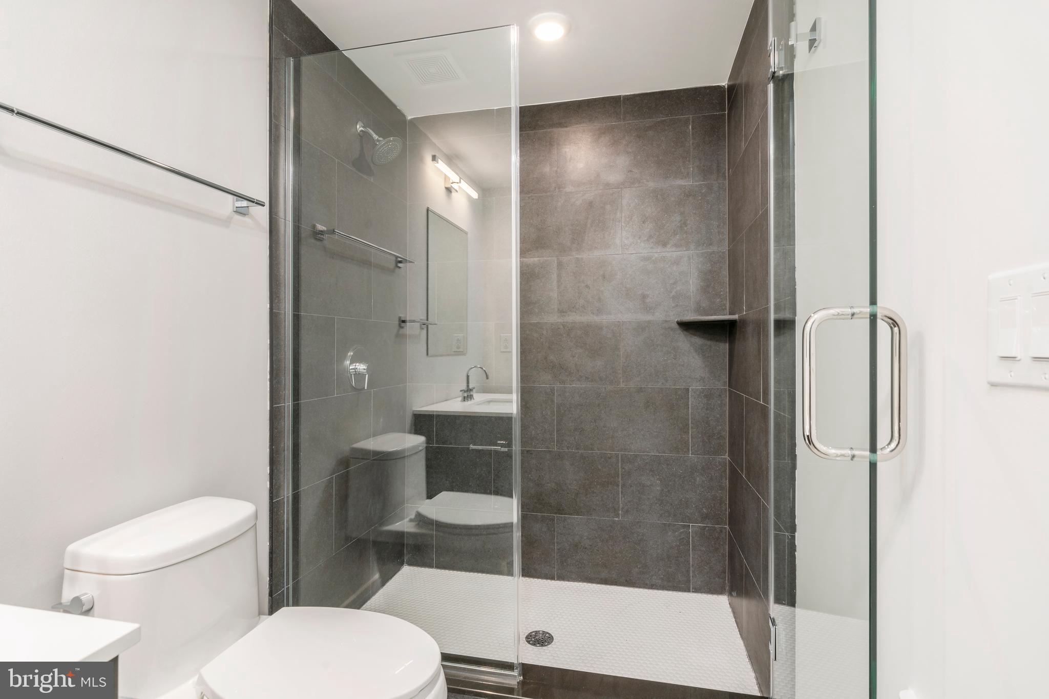 3449 Scotts Lane, Unit B323 Philadelphia, PA 19129 - Photo 11 of 21 a bathroom with a toilet and a shower