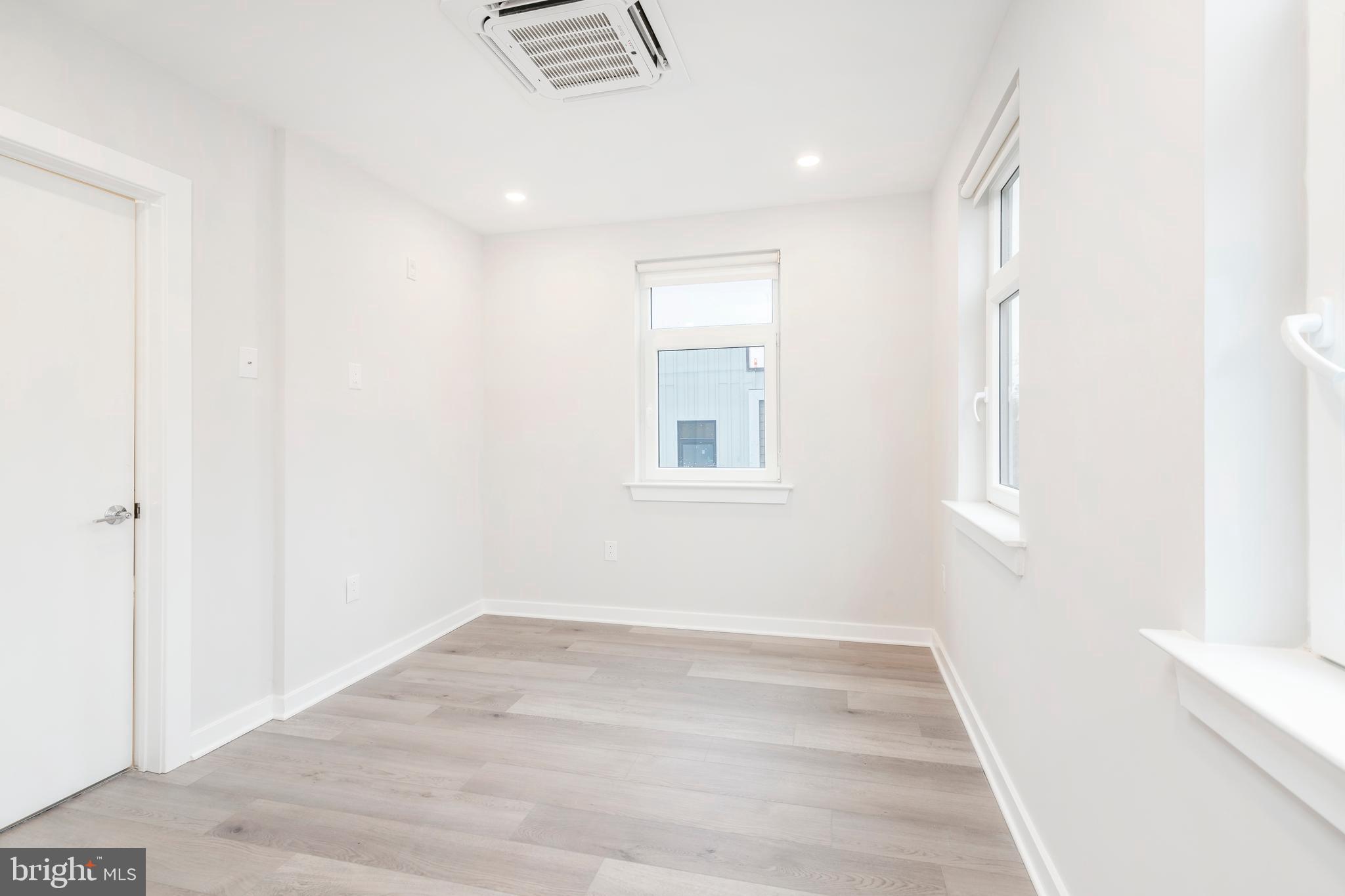 3449 Scotts Lane, Unit B323 Philadelphia, PA 19129 - Photo 15 of 21 a view of a room with wooden floor and a window