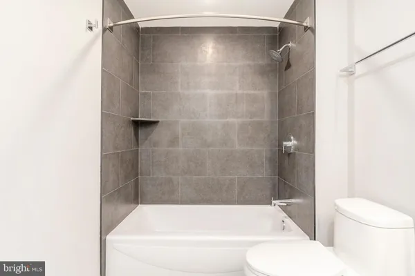 an empty room with windows and a sink