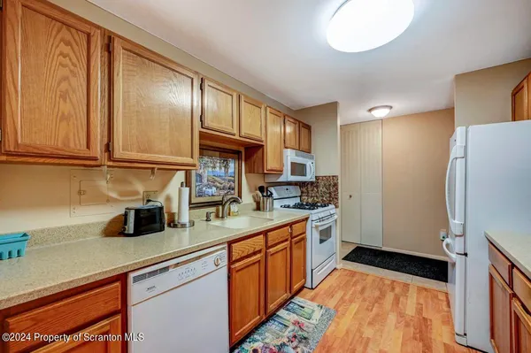 a kitchen with a sink a refrigerator and cabinets