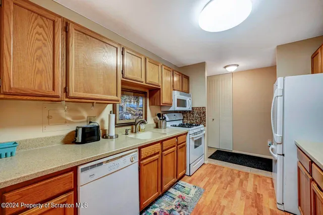 a kitchen with a sink a refrigerator and cabinets