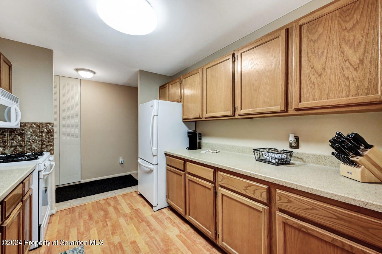 1102 Summit Pointe Scranton, PA 18508 - Photo 12 of 37 a kitchen with a sink a refrigerator and cabinets
