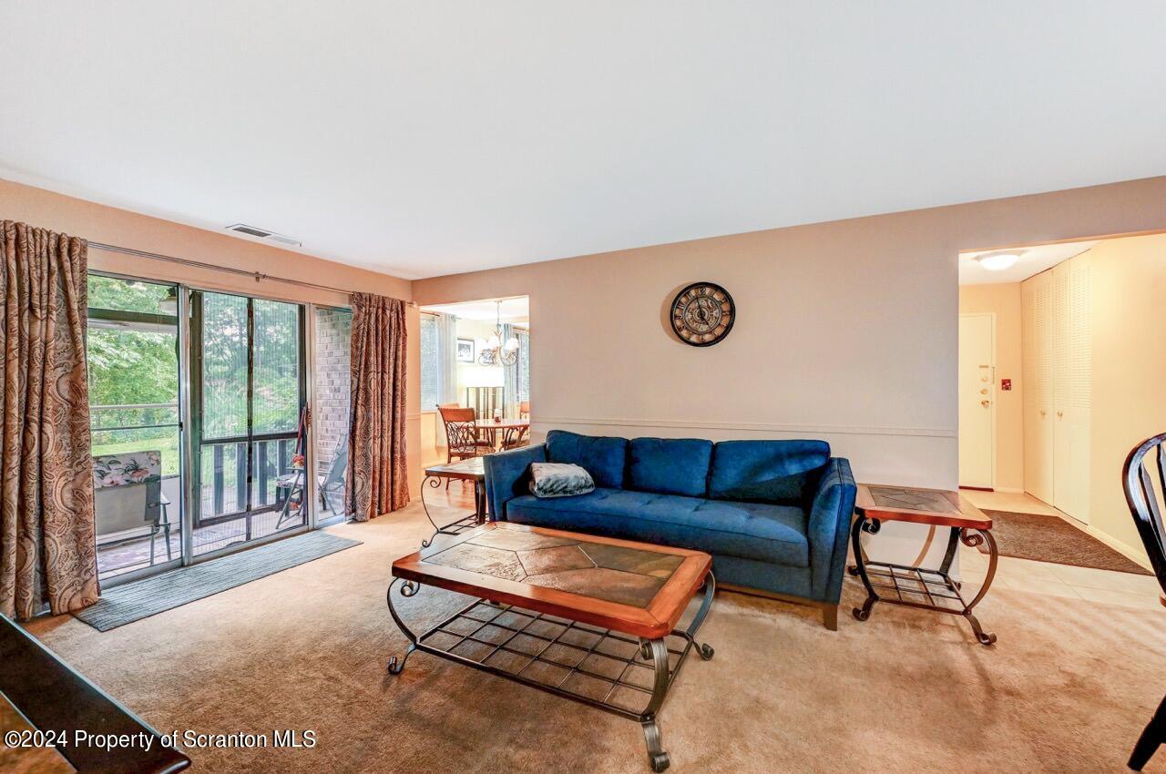 1102 Summit Pointe Scranton, PA 18508 - Photo 17 of 37 a living room with furniture and a floor to ceiling window
