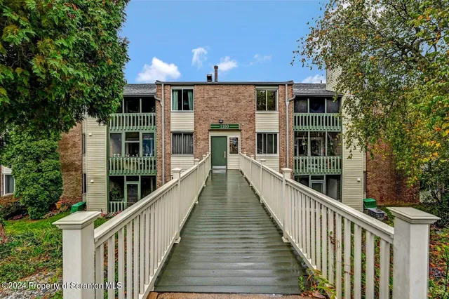 a view of a house with wooden deck