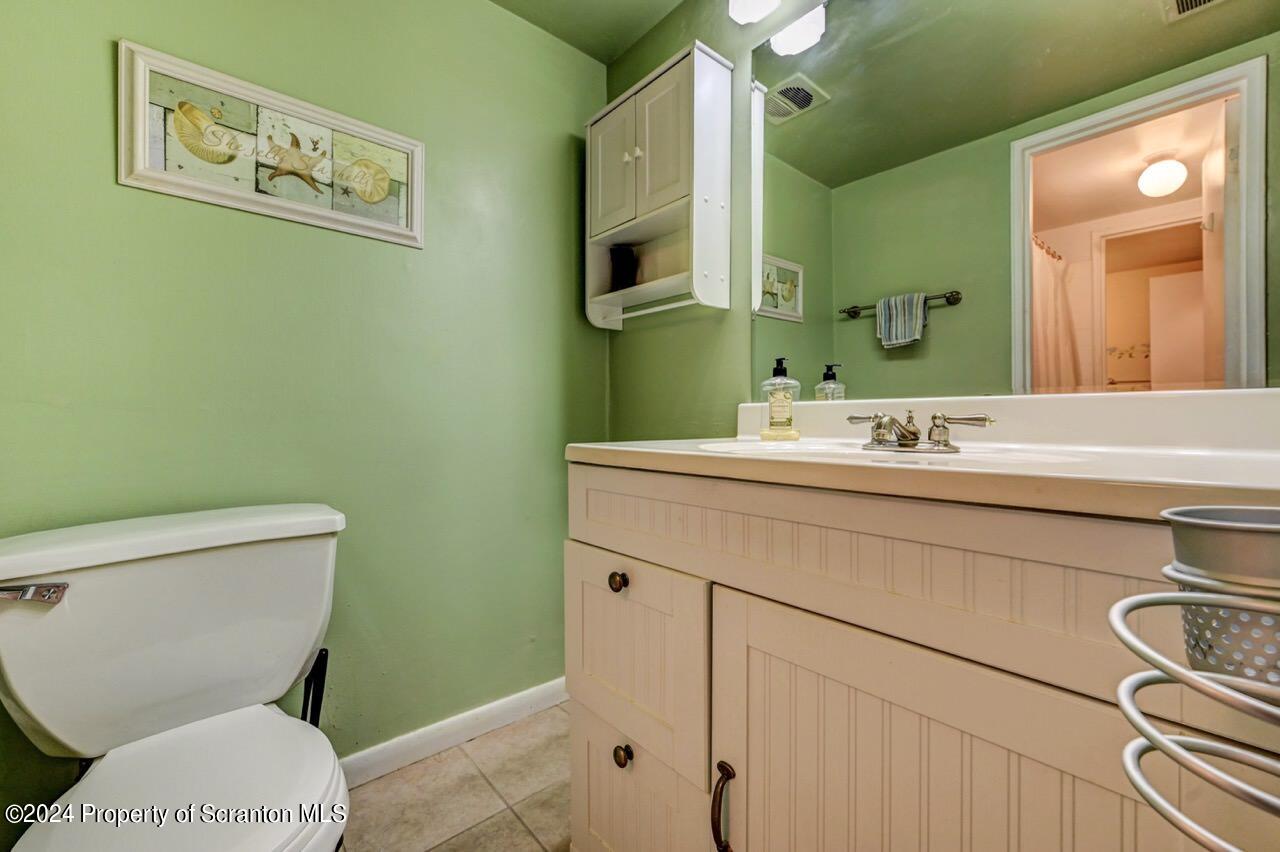 1102 Summit Pointe Scranton, PA 18508 - Photo 25 of 37 a bathroom with a toilet sink and mirror