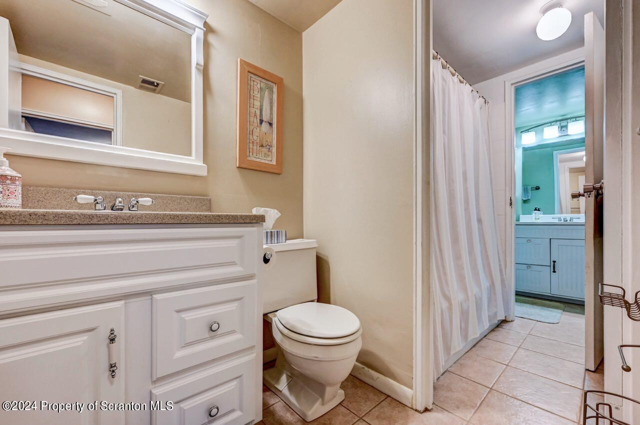 1102 Summit Pointe Scranton, PA 18508 - Photo 27 of 37 a bathroom with a toilet a sink and a mirror
