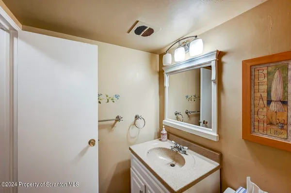 a bathroom with a sink vanity and mirror