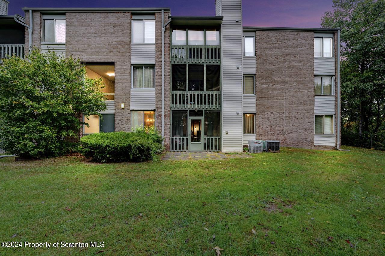 1102 Summit Pointe Scranton, PA 18508 - Photo 3 of 37 a front view of a brick house with a yard