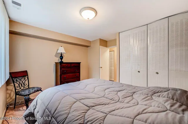 a bedroom with a bed and a dresser