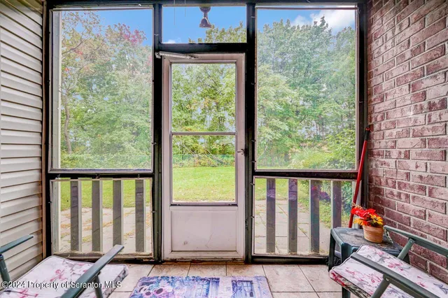 a view of a porch with a table and chairs