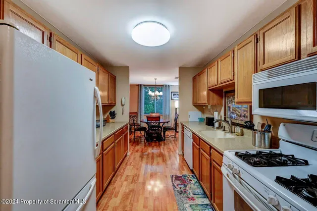 a kitchen with stainless steel appliances granite countertop a stove and a sink