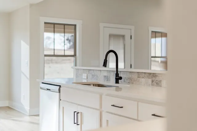 a close view of a sink and cabinets