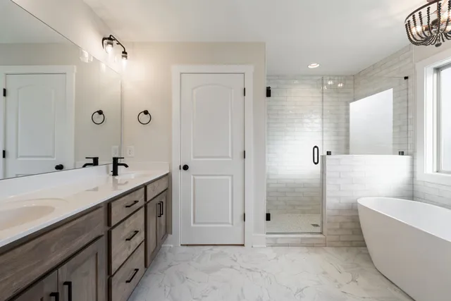 a bathroom with a tub sink and mirror