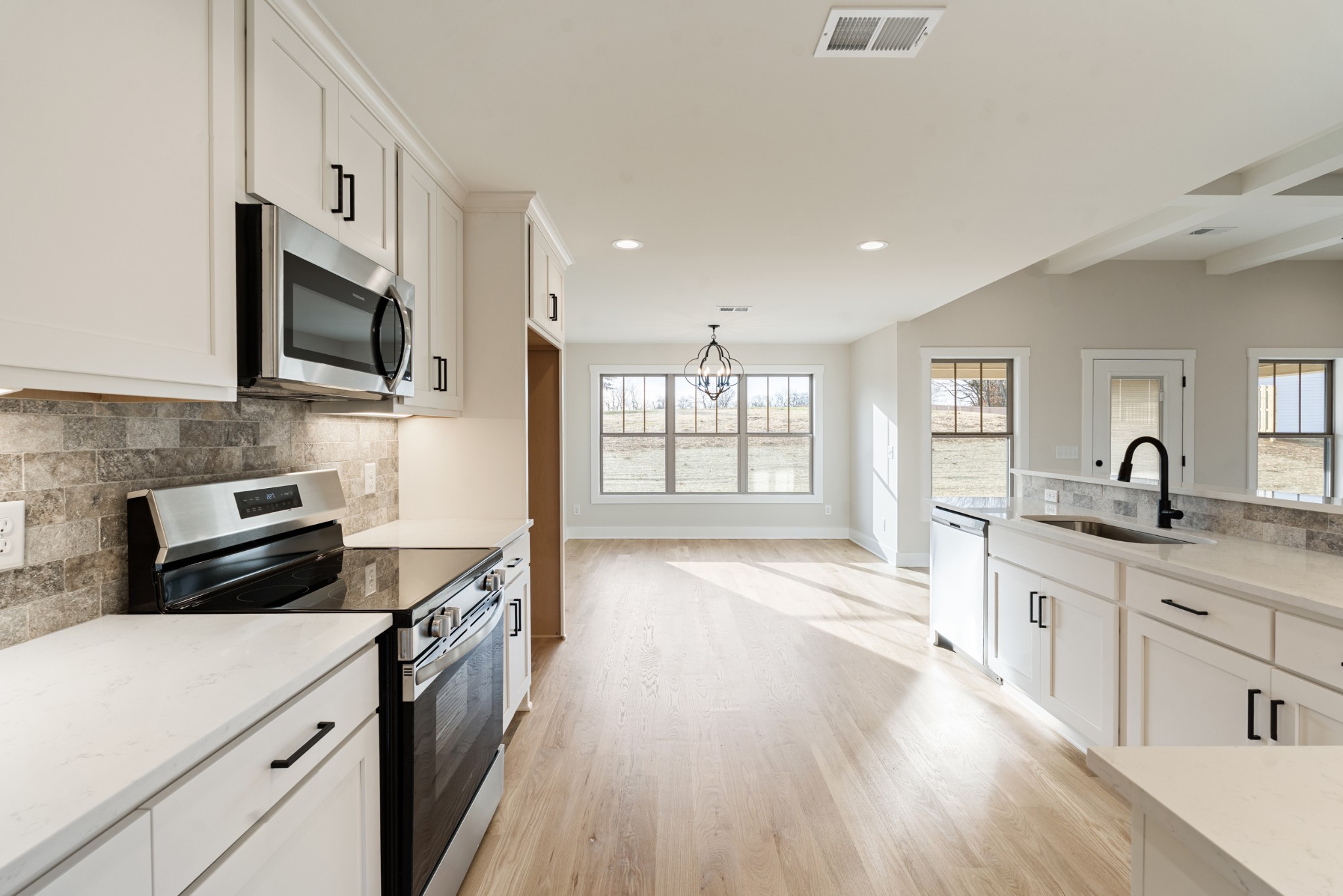 8078 Gideon Road Greenbrier, TN 37073 - Photo 10 of 26 a kitchen with stainless steel appliances a sink dishwasher stove microwave and cabinets