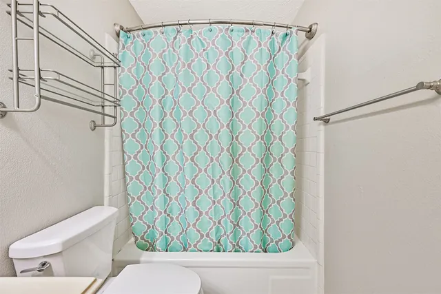 a bathroom with a shower curtain and sink