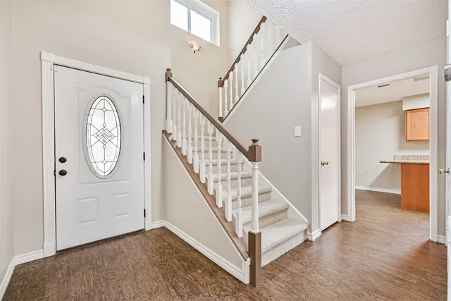 a view of an entryway with wooden floor