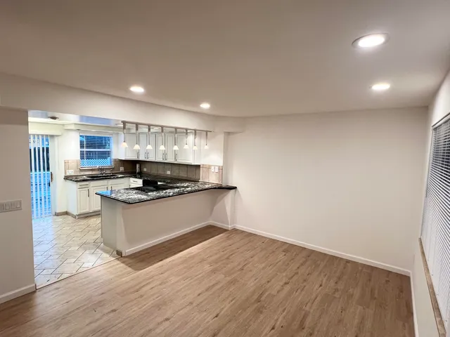 a kitchen with a refrigerator and a stove top oven