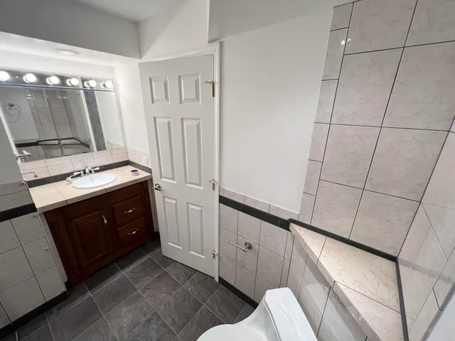 a spacious bathroom with a double vanity sink a mirror and a vanity