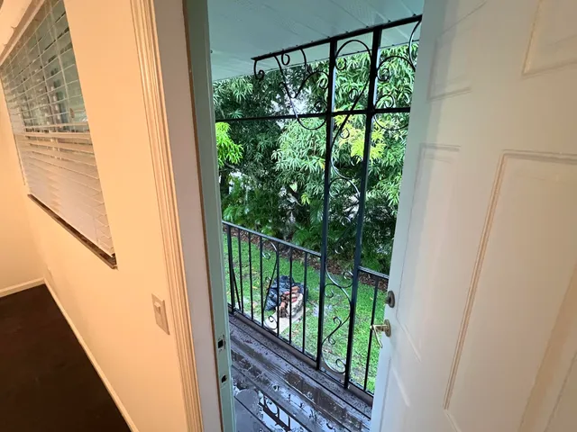 a view of a balcony with wooden floor