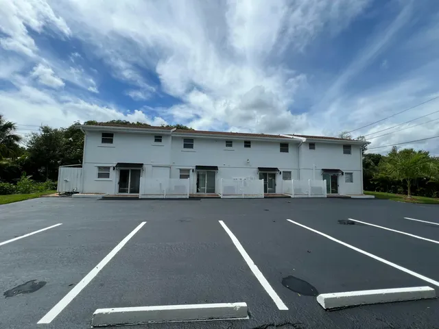 a view of a big room with windows and brick wall