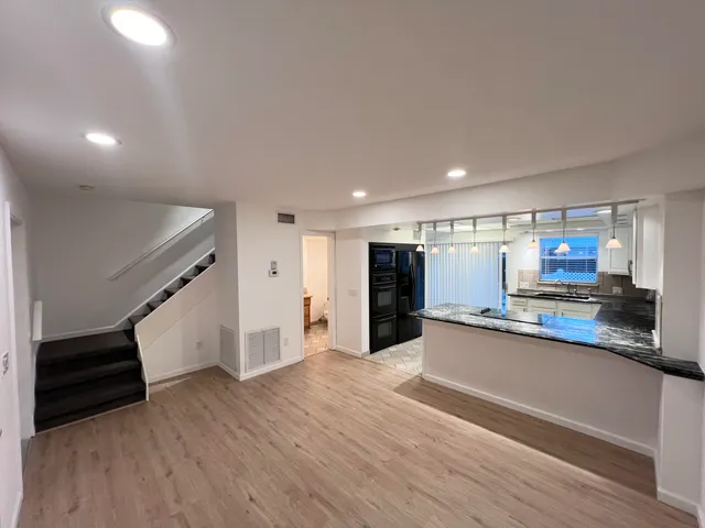 a kitchen with stainless steel appliances a refrigerator and a counter top space