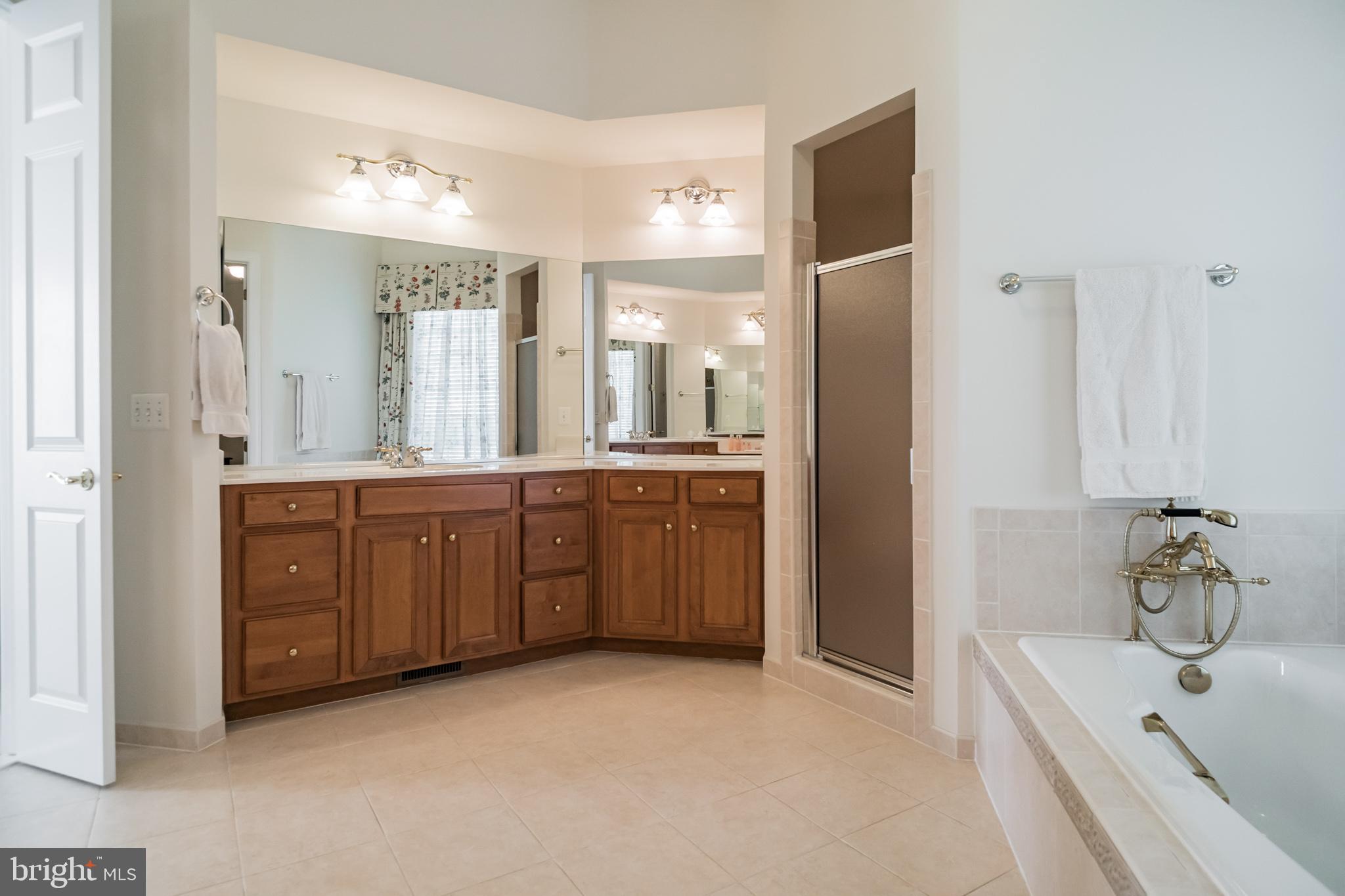 8514 Link Hills Loop Gainesville, VA 20155 - Photo 28 of 65 Owner's Bath, dual shower head and shower bench